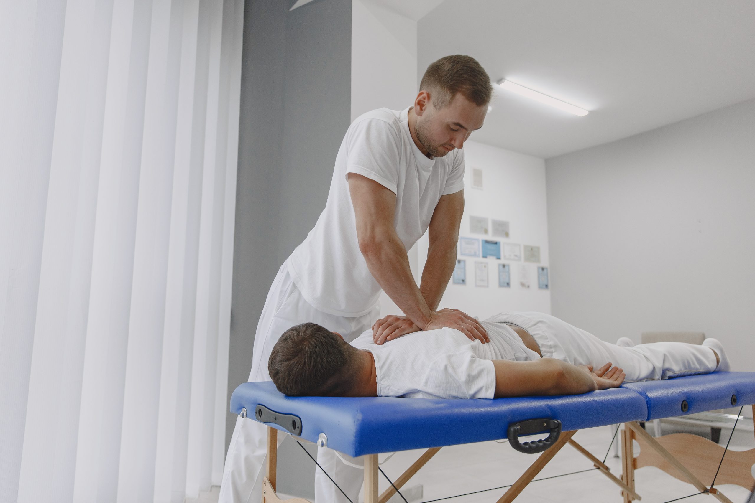 Chiropractor providing care to a patient lying on a table