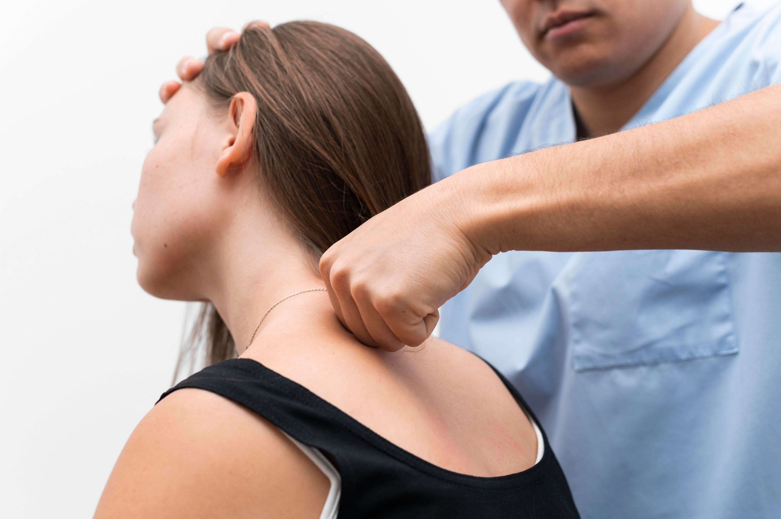 A chiropractor relieves back pain for a patient