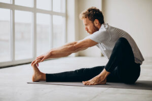 A man stretches to prevent muscle cramps